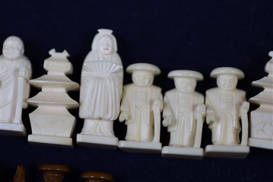 An unusual late 19th century Japanese brown stained and natural ivory figural chess set, kings 1.75in.